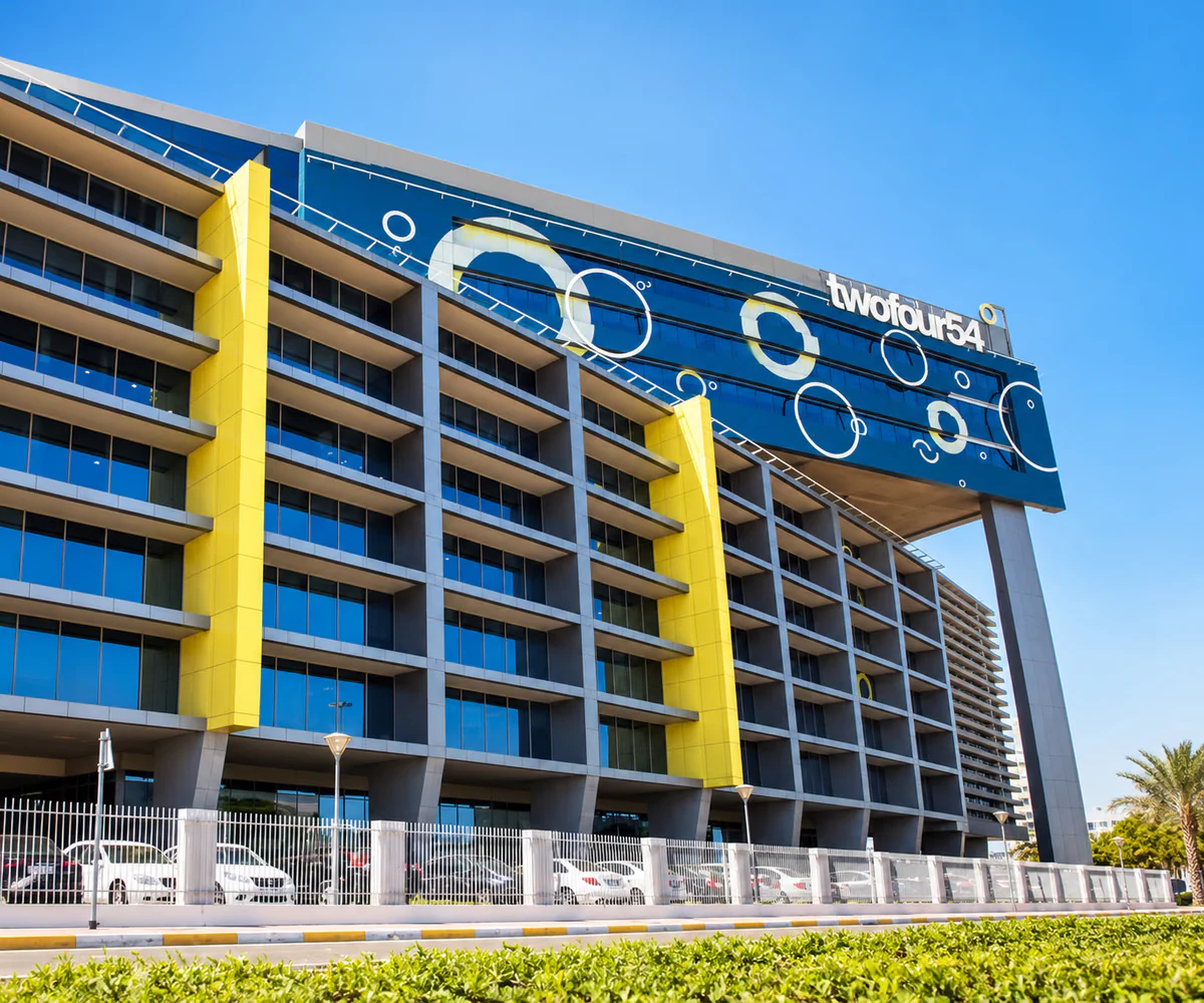 twofour54 media free zone, Abu Dhabi: office building with the twofour54 name on its blue and yellow facade
